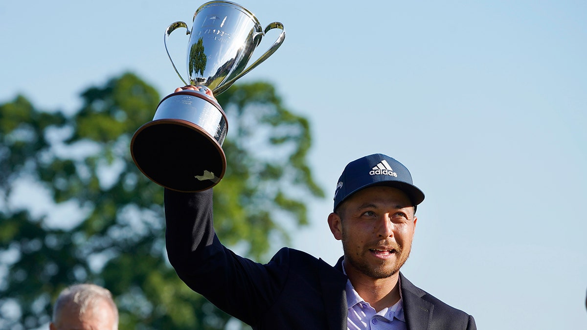 Xander Schauffele holds the trophy