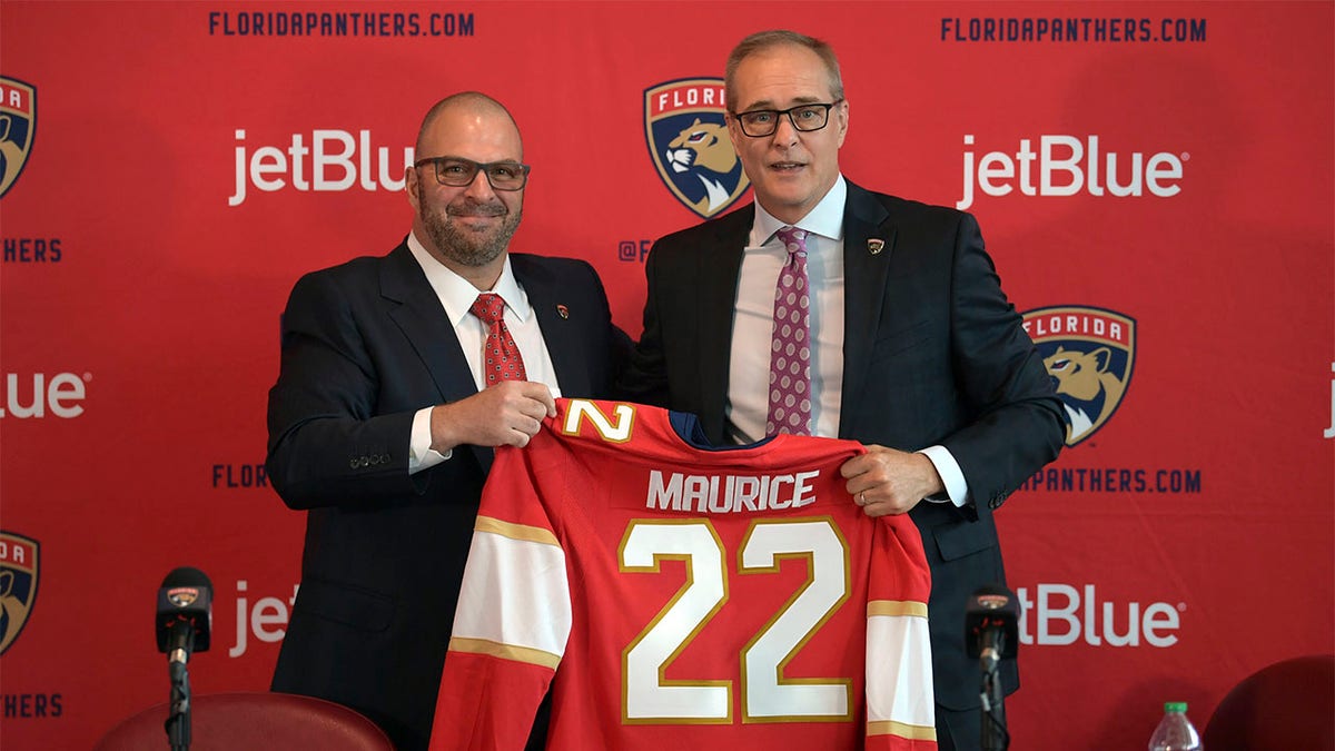 Bill Zito and Paul Maurice holding a jersey