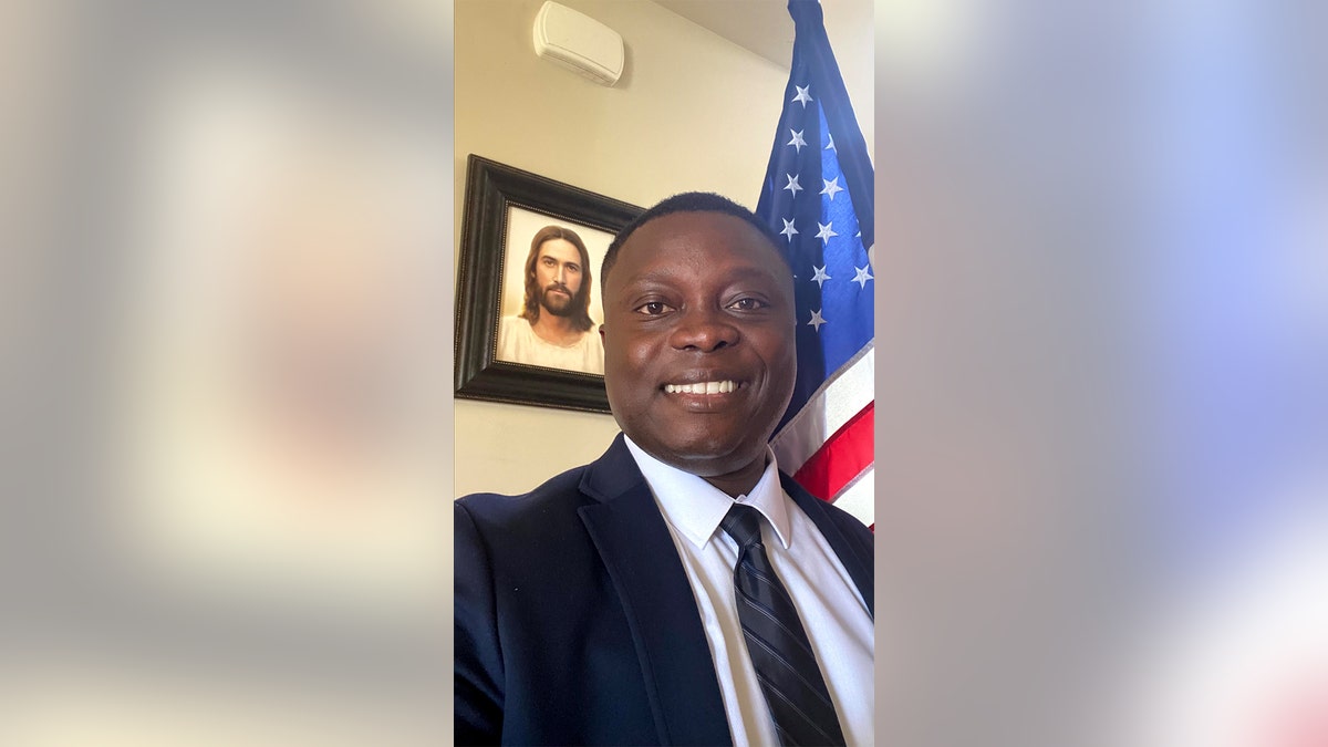Ghanaian immigrant posing with American flag 