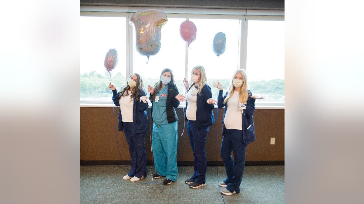 Pregnant nurses at Saint Luke's East Hospital hold 'Boy or Girl' balloons
