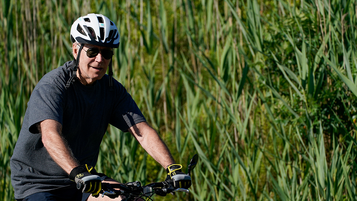 Biden rides bicycle Rehoboth, Delaware beach.