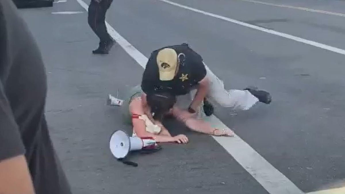 biden protester tackled