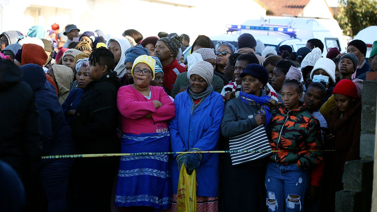 Bystanders stand outside of South Africa club