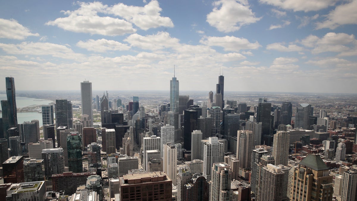 An aerial shot of Chicago with white clouds in a blue sky