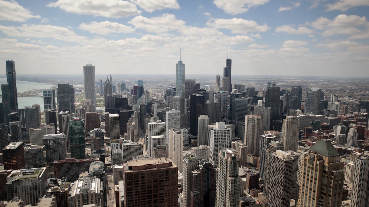 An aerial shot of Chicago with white clouds in a blue sky