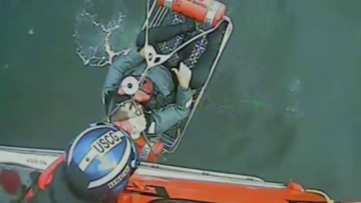 coast guard pulls sailor from water