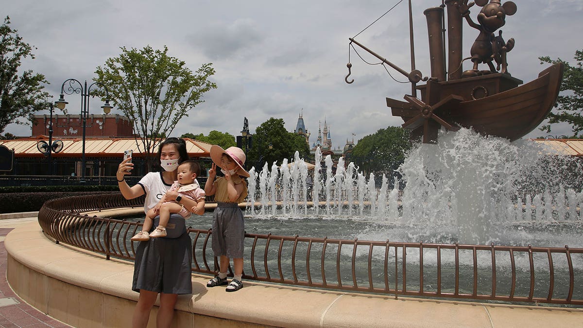 Family takes photo at Disney in China