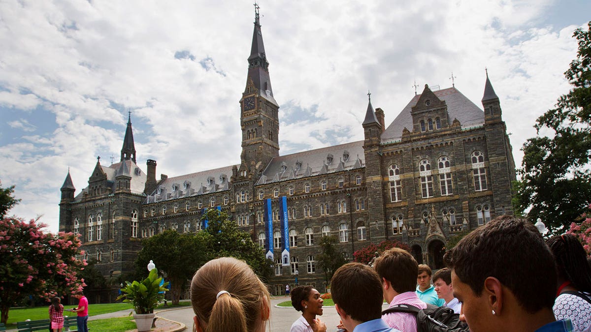 Students walk around Georgetown campus during daytime, Georgetown school building
