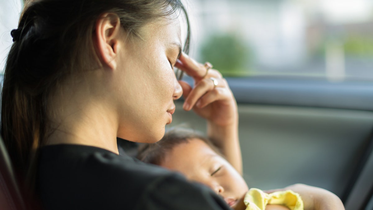 tired mother with baby