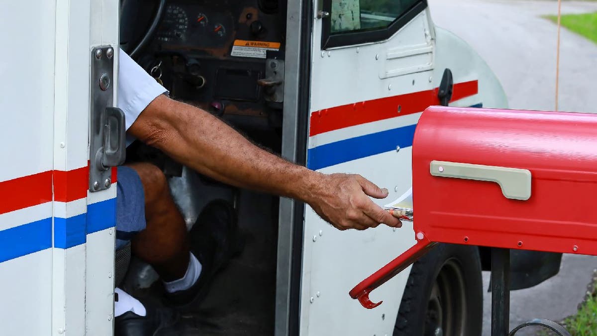 Mailman delivering mail from truck