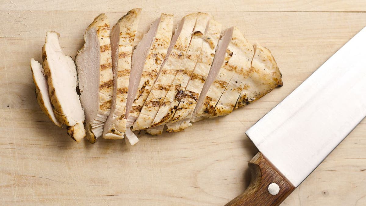 Grilled chicken strips on wood cutting board
