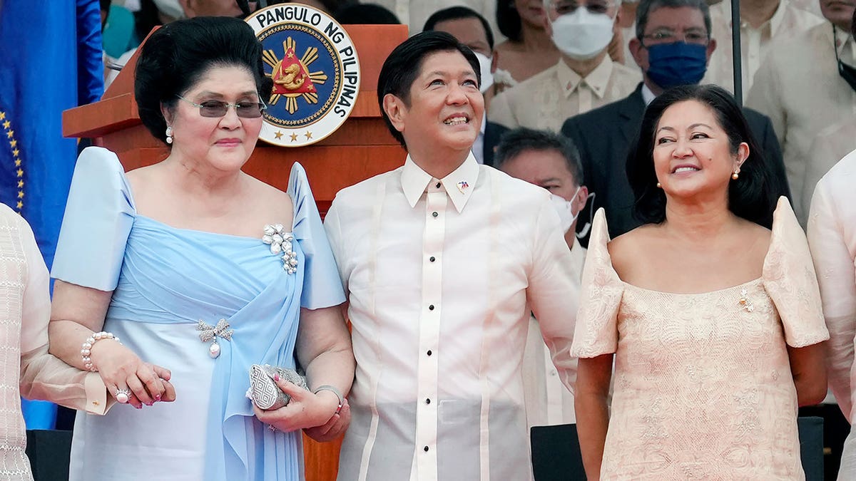 Marcos, wife, and mother during inauguration cereemony