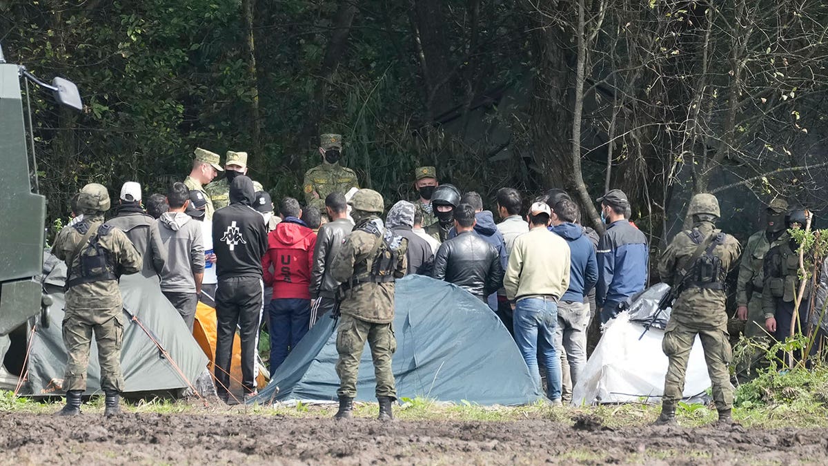Military hold back migrants at Polish border