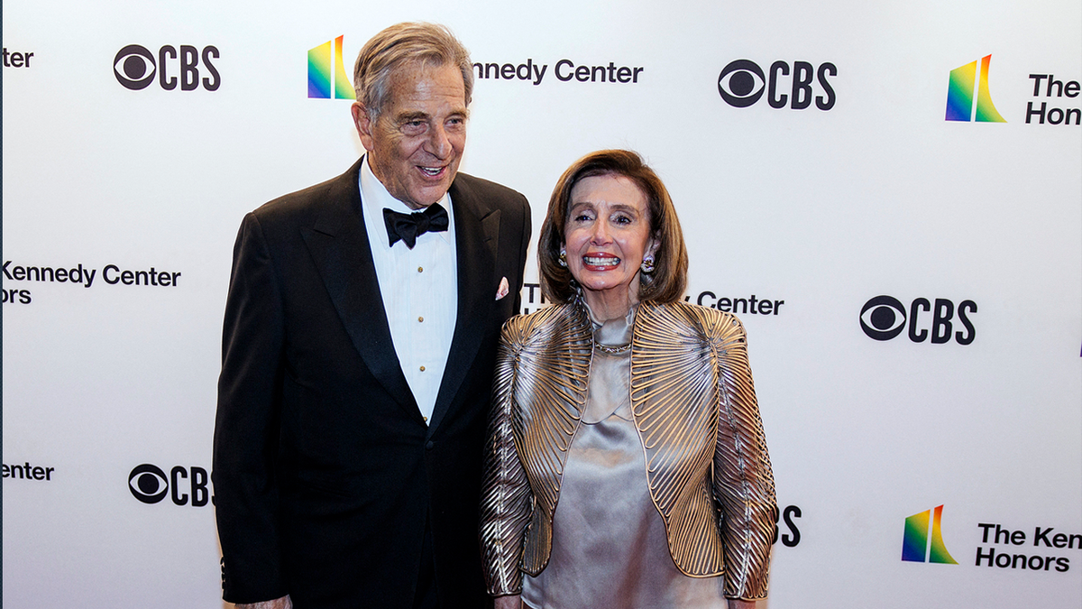 Nancy Pelosi in a dress and Paul Pelosi in a tux at an award ceremony