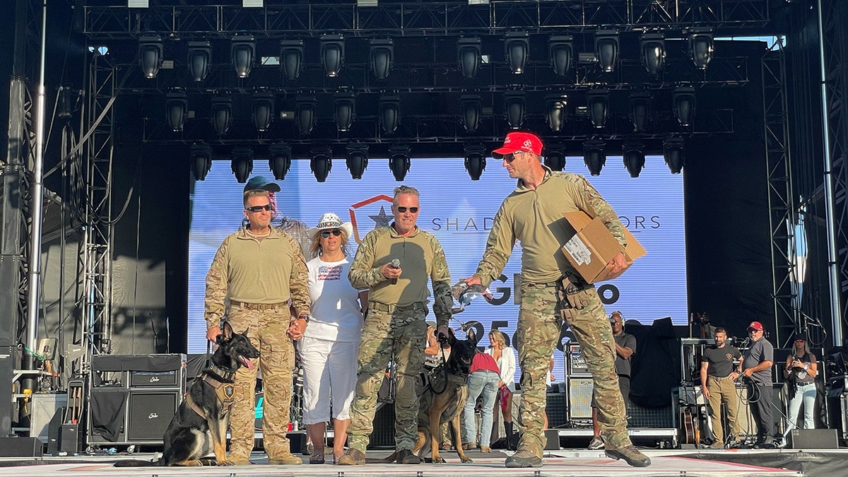 Baden K9 owner hands out. "Make 22 Zero Again" hats on stage.