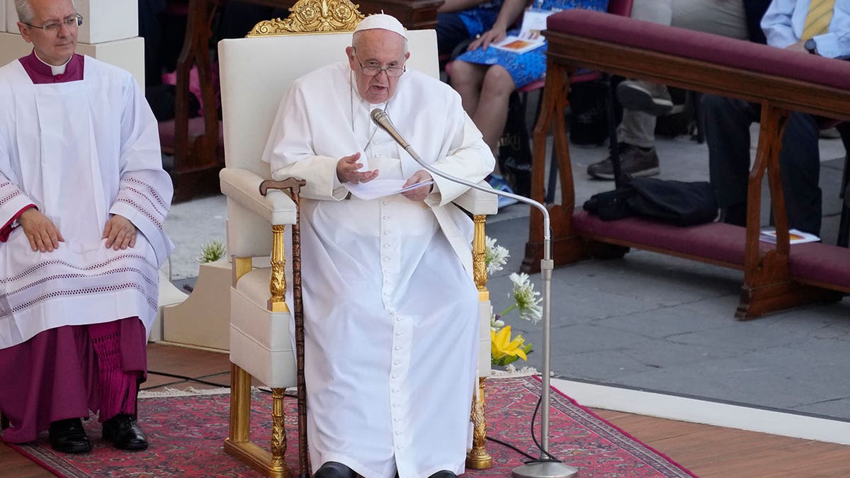 The pope sitting during a mass