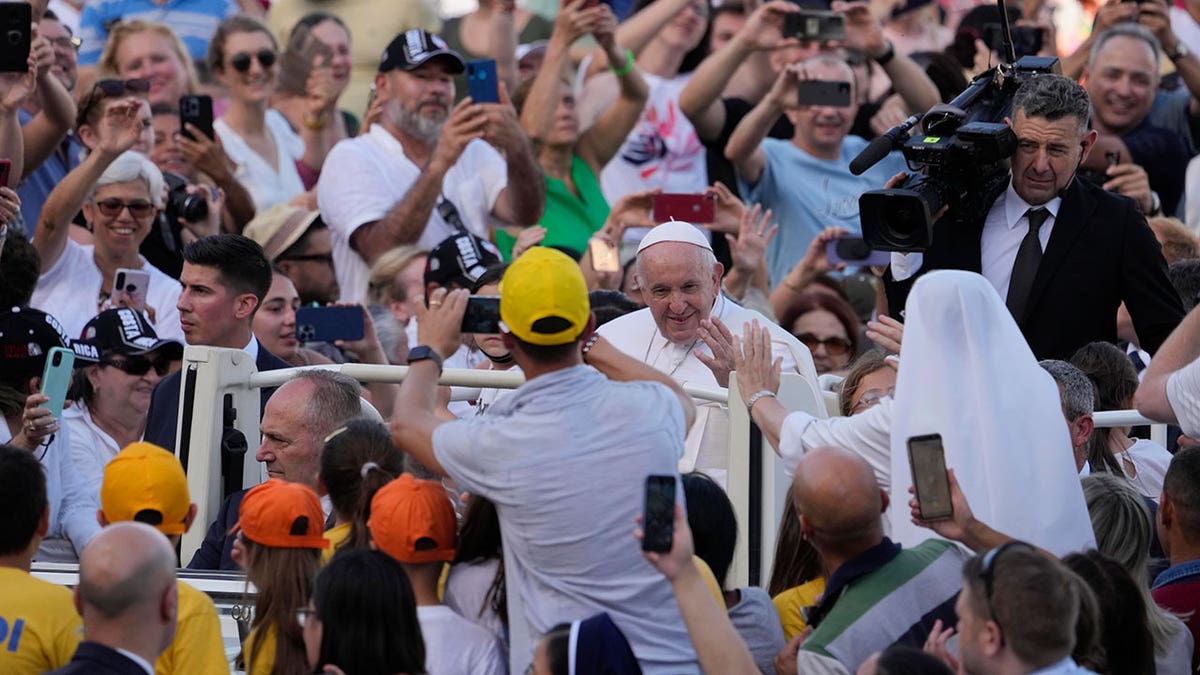 The pope greeting followers and fans