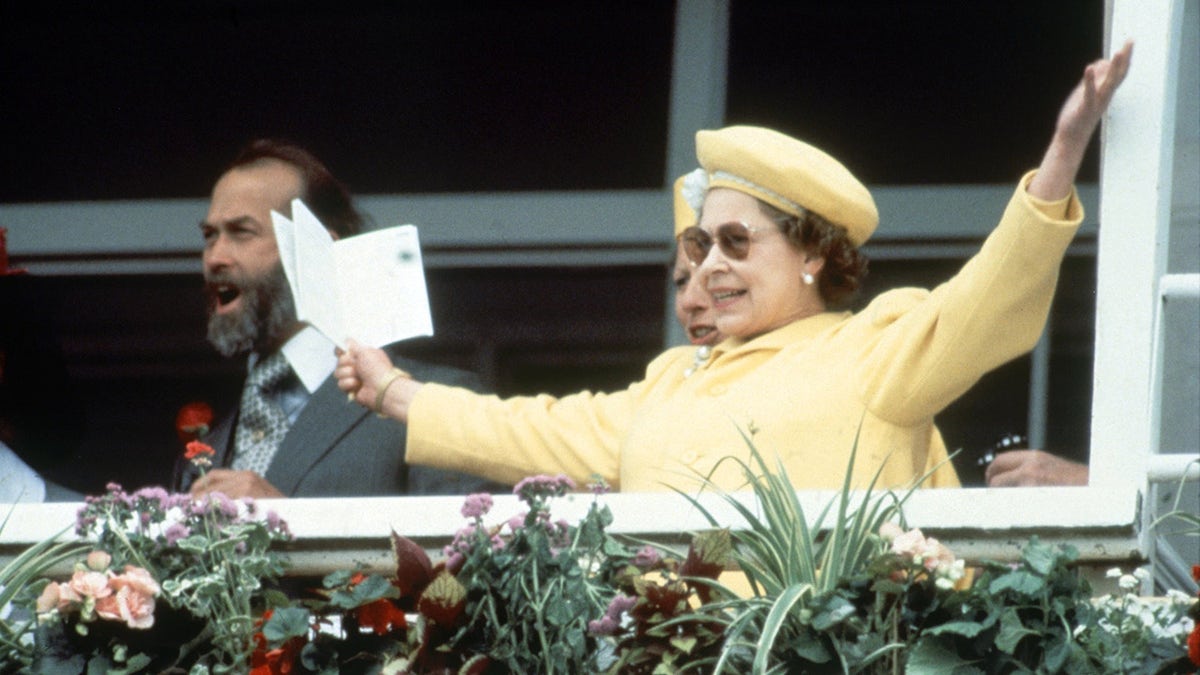 Queen Elizabeth celebrates a win at the races