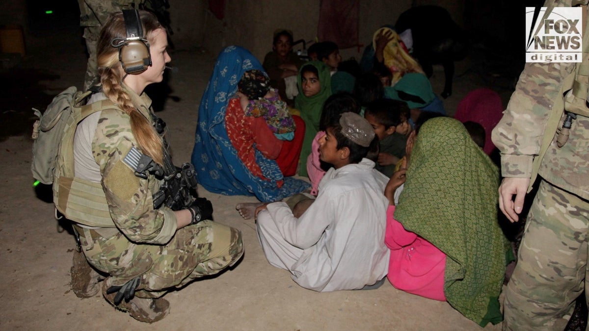 Female soldier near kids
