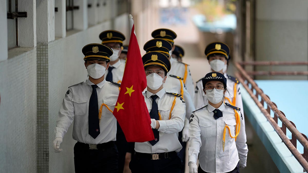 Uniformed Chinese students celebrating Hong Kong anniversary