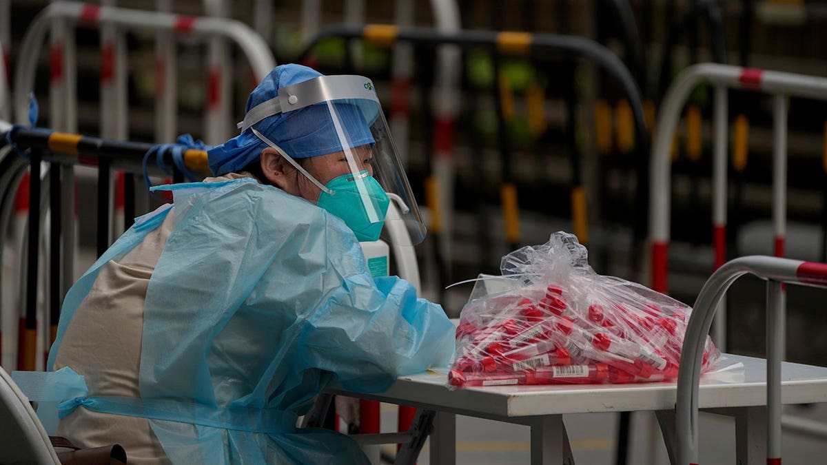 Volunteer wears protective gear in Beijing