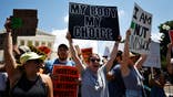 A woman holds a pro-choice sign