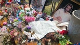 Signs and flowers lay in Uvalde's town square memorial