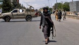 Taliban fighters at explosion site