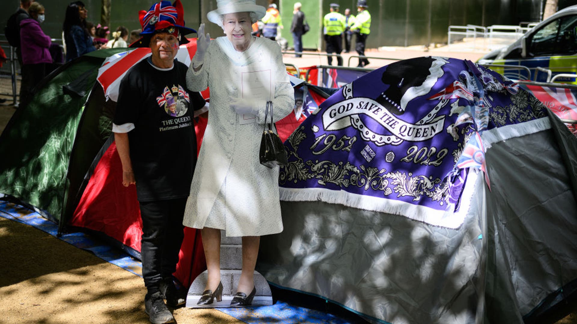 John Loughrey holds up a cardboard cut-out of Queen Elizabeth