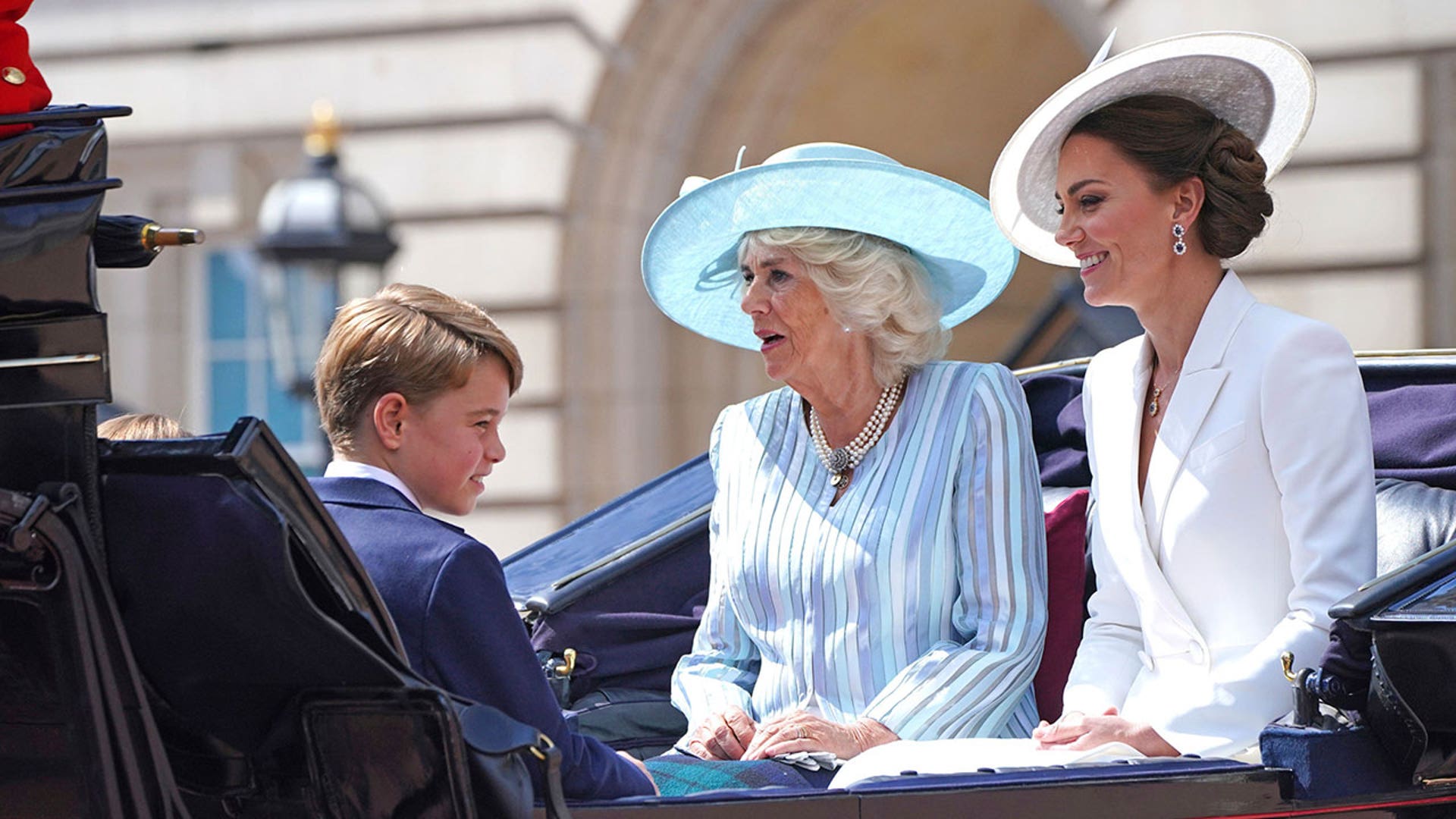 Kate, Camilla, and George riding in a carriage during Trooping of the Colour