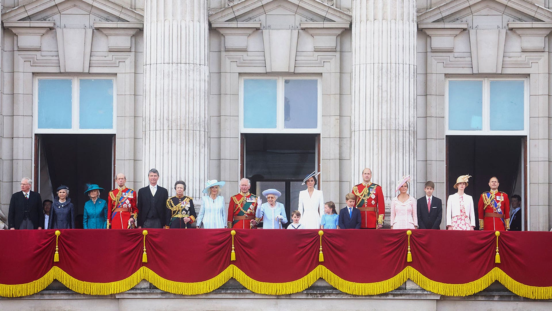 Royal family standing on balcony during parade