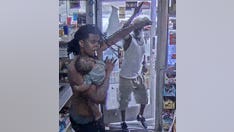 Detroit gas station video shows armed suspect drawing gun on man holding baby on shoulder