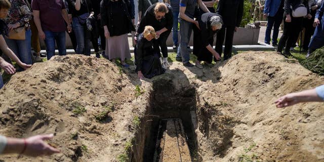 Relatives of Army Col. Oleksander Makhachek mourn during his funeral in Zhytomyr, Ukraine, on Friday, June 3.