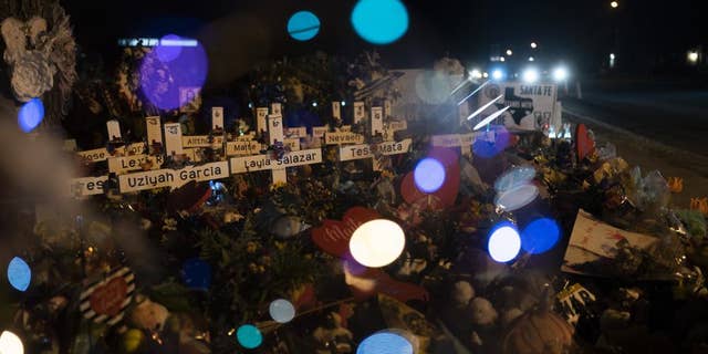 Crosses bearing the names of the victims killed in the Uvalde, Texas, school shooting are seen through a balloon at a memorial at Robb Elementary School on Wednesday, June 1.