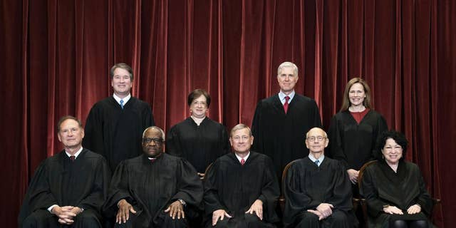Members of the Supreme Court pose for a group photo at the Supreme Court in Washington, April 23, 2021. Seated from left are Associate Justice Samuel Alito, Associate Justice Clarence Thomas, Chief Justice John Roberts, Associate Justice Stephen Breyer and Associate Justice Sonia Sotomayor, Standing from left are Associate Justice Brett Kavanaugh, Associate Justice Elena Kagan, Associate Justice Neil Gorsuch and Associate Justice Amy Coney Barrett. The Supreme Court has ended constitutional protections for abortion that had been in place nearly 50 years 