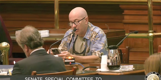 A Texas resident speaks to the Senate Special Committee to Protect All Texans during a public comments section of a 12-hour hearing.