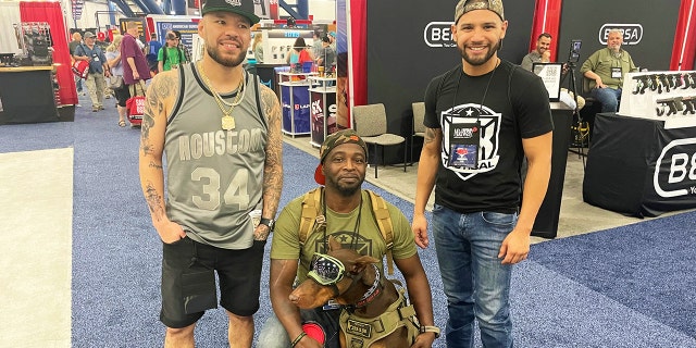 Jay Cee and friends attend the 2022 NRA convention with his dog Ace.