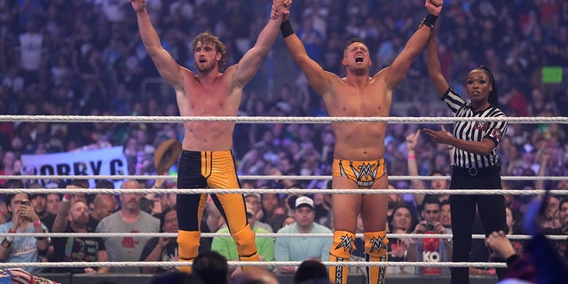 Logan Paul (left) and the Miz celebrate after winning the tag-team match between The Mysterios and The Miz and Logan Paul during WrestleMania at AT and T Stadium. 