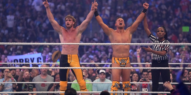 Logan Paul (left) and the Miz celebrate after winning the tag-team match between The Mysterios and The Miz and Logan Paul during WrestleMania at AT and T Stadium.