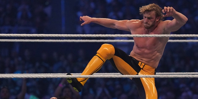 Logan Paul (yellow pants) attacks Dominik Mysterio during the tag-team match between The Mysterios and The Miz and Logan Paul during WrestleMania at AT and T Stadium. 