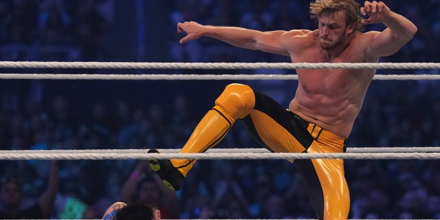 Logan Paul (yellow pants) attacks Dominik Mysterio during the tag-team match between The Mysterios and The Miz and Logan Paul during WrestleMania at AT and T Stadium.