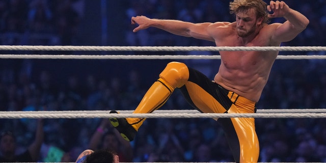 Logan Paul (yellow pants) attacks Dominik Mysterio during the tag-team match between The Mysterios and The Miz and Logan Paul during WrestleMania at AT and T Stadium. 