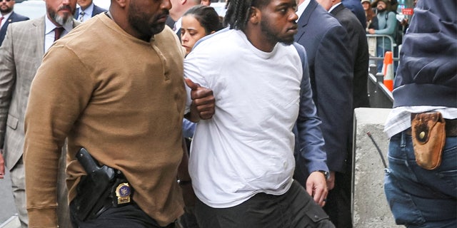New York Subway shooting suspect Andrew Abdullah is escorted by New York City Police Detectives in to a Police Precinct in New York City, U.S., May 24, 2022.