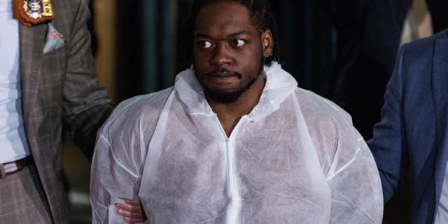 New York Subway shooting suspect Andrew Abdullah is escorted by New York City Police Detectives as he exits arrested from the Police Precinct in New York City, U.S., May 24, 2022.