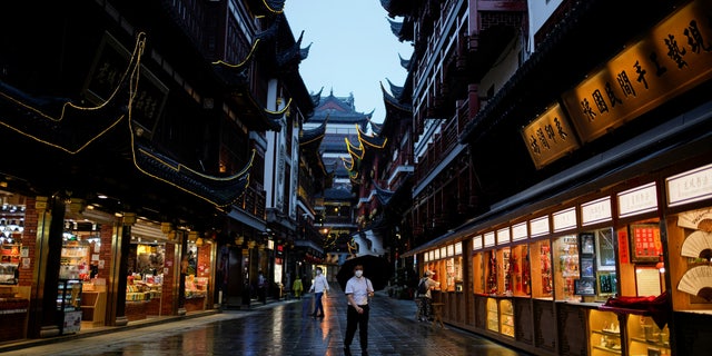 People wearing protective masks walk in Yu Garden amid new lockdown measures in parts of the city to curb the COVID-19 outbreak in Shanghai, China.  June 10, 2022.