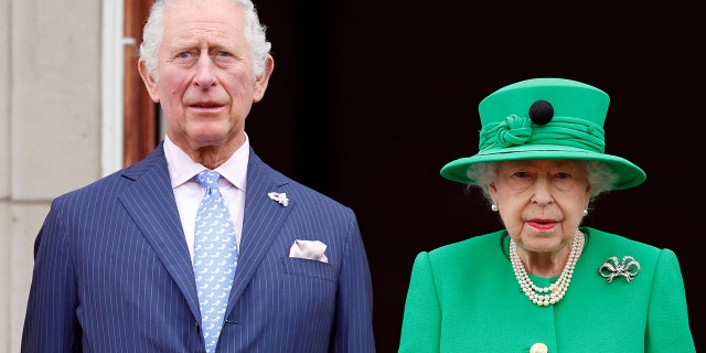 Prince Charles and Queen Elizabeth II stand on the balcony of Buckingham Palace following the Platinum Pageant on June 5, 2022, in London.