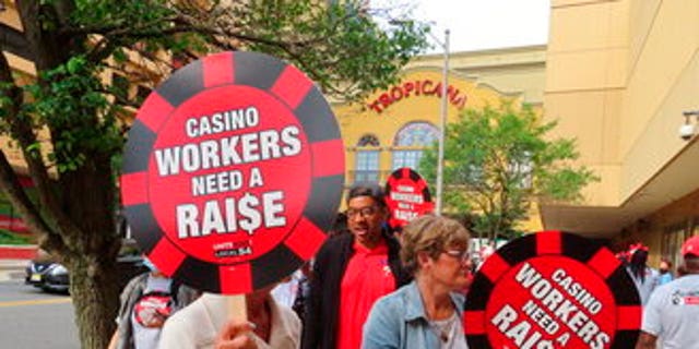 Members of Local 54 of the Unite Here casino workers union picket outside the Tropicana casino in Atlantic City N.J. on June 1, 2022. (AP Photo/Wayne Parry)