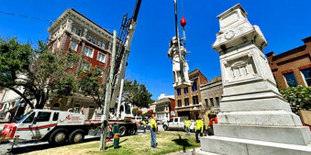 A Confederate monument is moved from the center of Macon, Georgia. The monument will be relocated to Whittle Park in front of Rose Hill Cemetery.