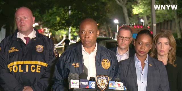 New York City Mayor Eric Adams stands with Police Commissioner Keechant L. Sewell during a 10:30 p.m. press conference. 