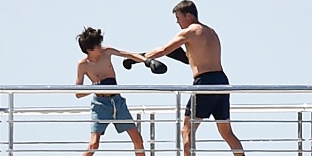 Brady has a training session with his son while vacationing on a yacht in Portofino, Italy. 